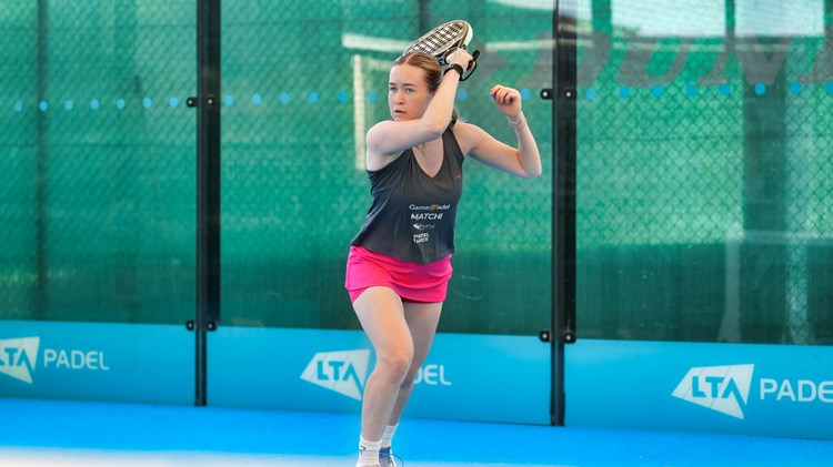 Tia Norton hits a forehand shot on a padel court at the National Tennis Centre