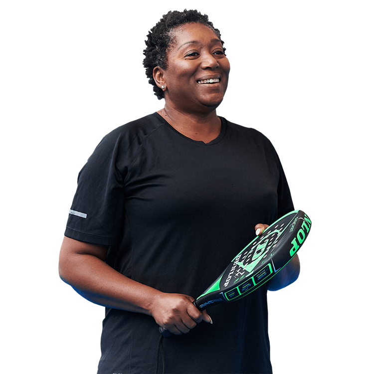 Women smiling holding a padel racket 